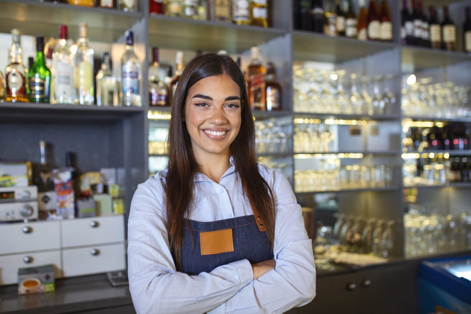 Waitress wearing apron smilling looking at camera. Happy businesswoman. Small business owner of girl entrepreneur. Cafe employee posing in restaurant coffee shop