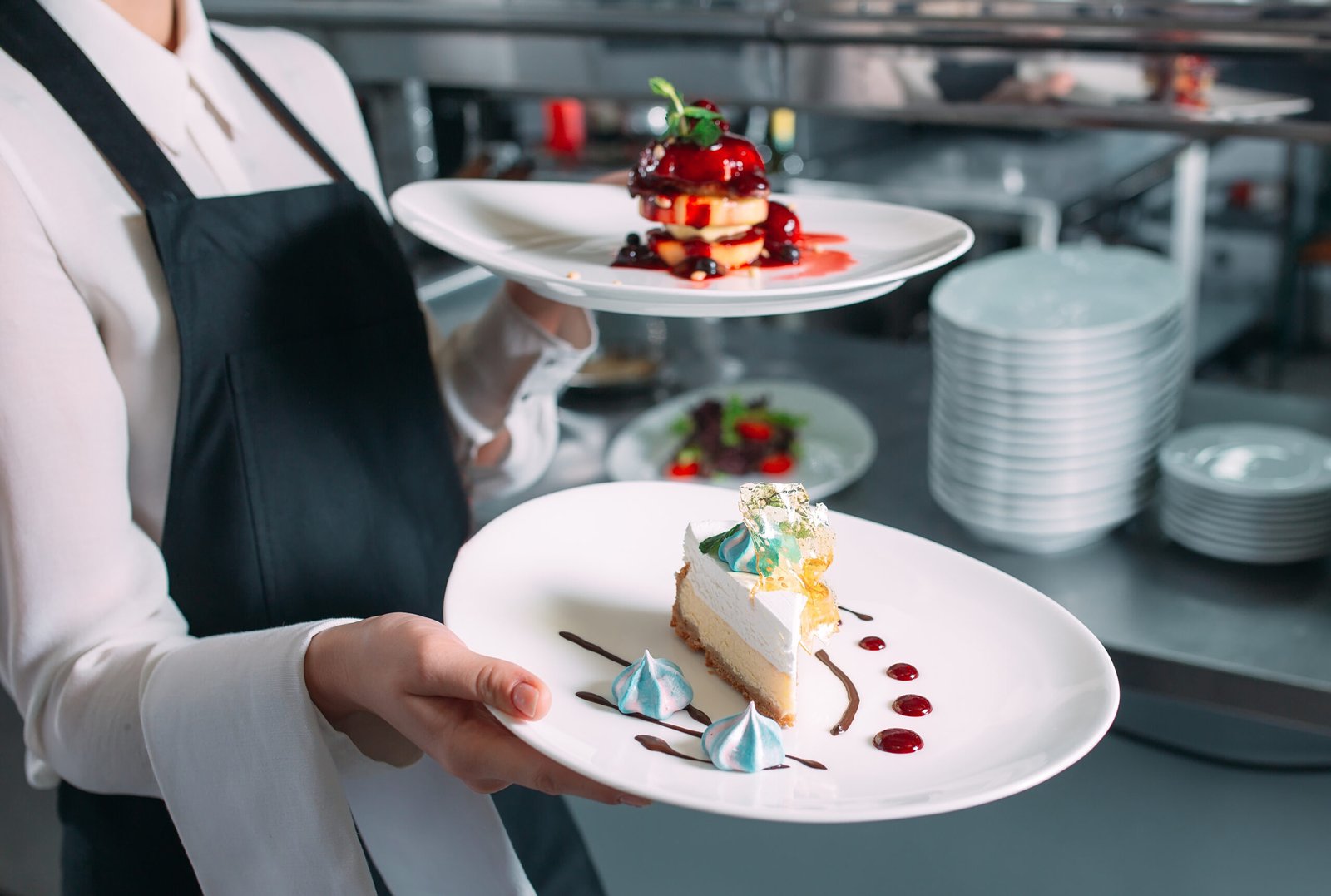 Waiter serving in motion on duty in restaurant. The waiter carries dishes